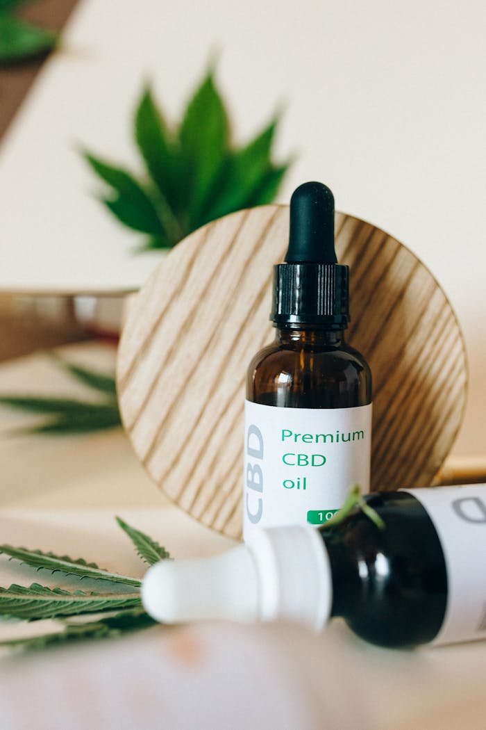 Elegant product shot of premium CBD oil with dropper and cannabis leaf for wellness and health benefits.